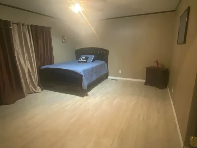 a bedroom with a bed and a mirror