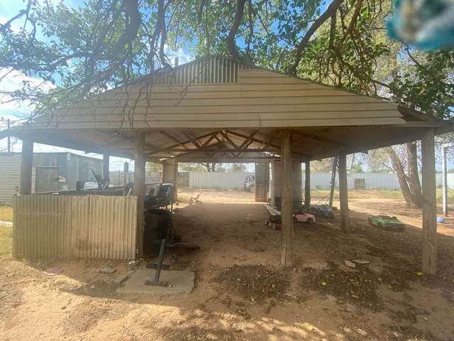 a backyard of a house with a shaded area