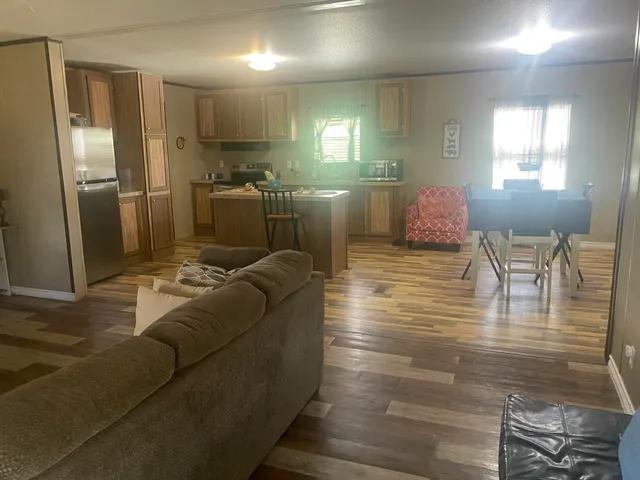 a living room with lots of furniture and a wooden floor