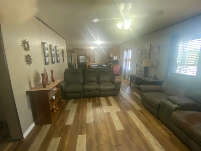 a living room with couch and wooden floor