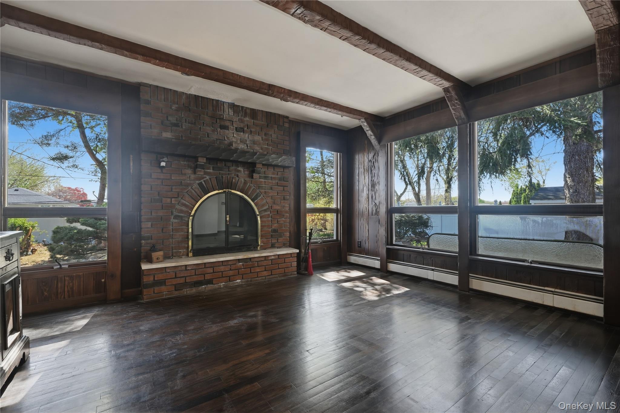 19 Gaymor Lane Commack, NY 11725 - Photo 10 of 25 a view of empty room with wooden floor and floor to ceiling window