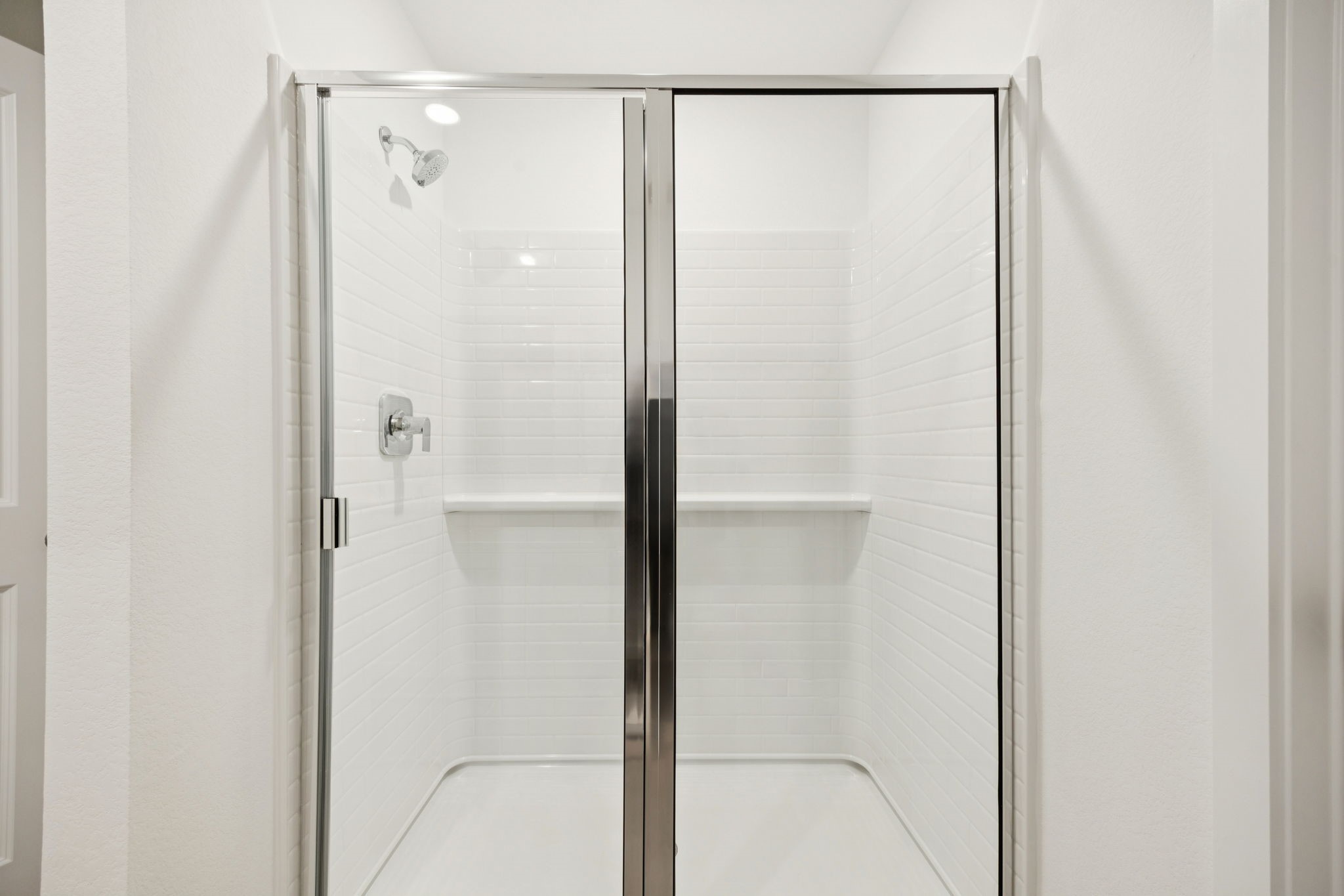 26266 Arrowleaf Drive Magnolia, TX 77355 - Photo 20 of 30 a bathroom with a glass shower door