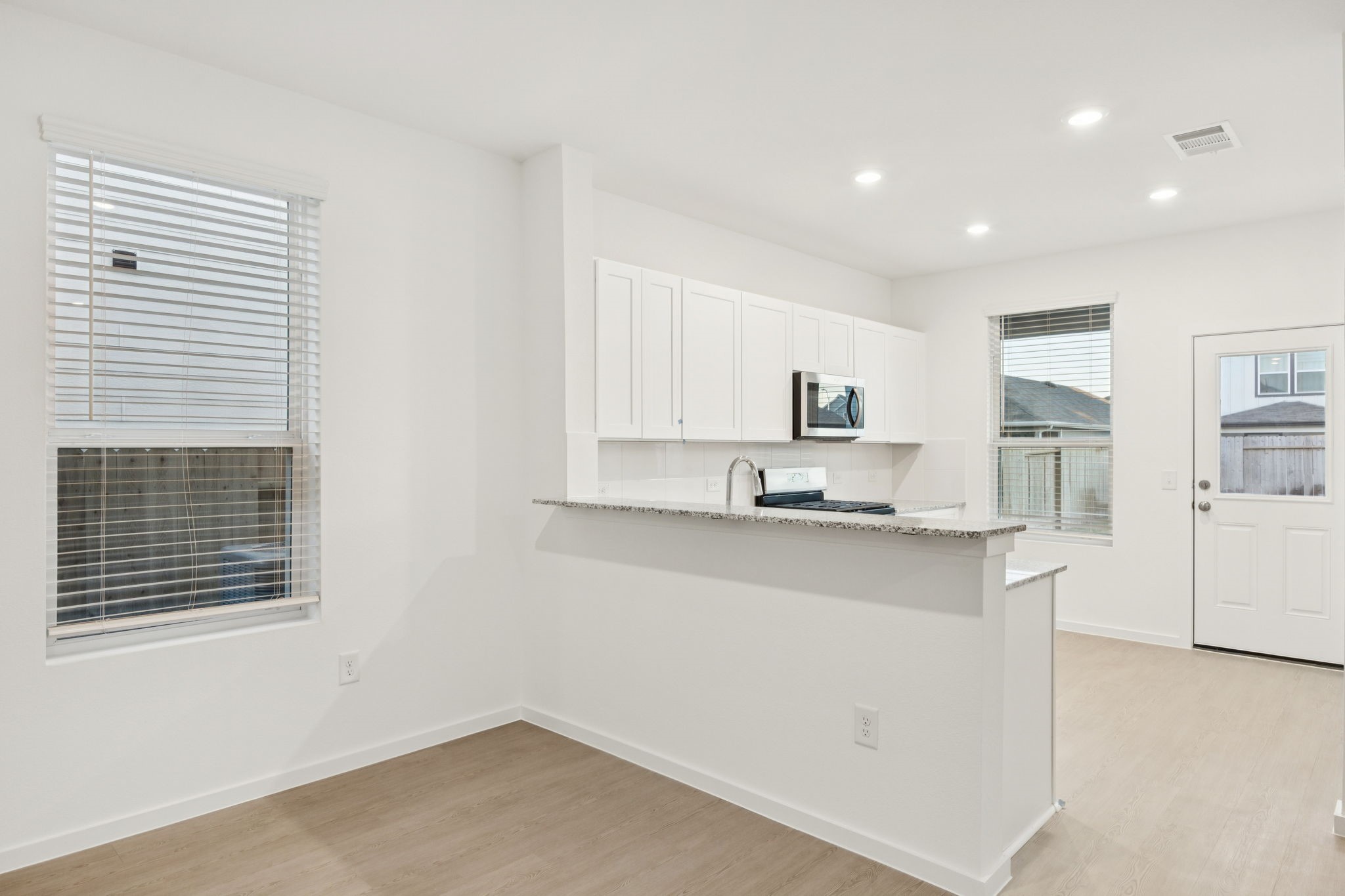 26266 Arrowleaf Drive Magnolia, TX 77355 - Photo 5 of 30 a kitchen with stainless steel appliances a sink stove and cabinets