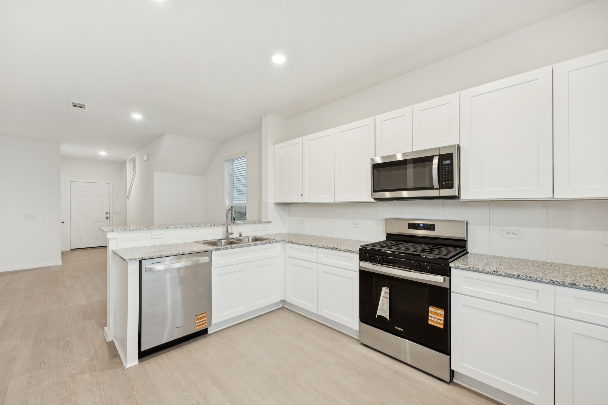 26266 Arrowleaf Drive Magnolia, TX 77355 - Photo 8 of 30 a kitchen with stainless steel appliances a stove sink microwave and cabinets