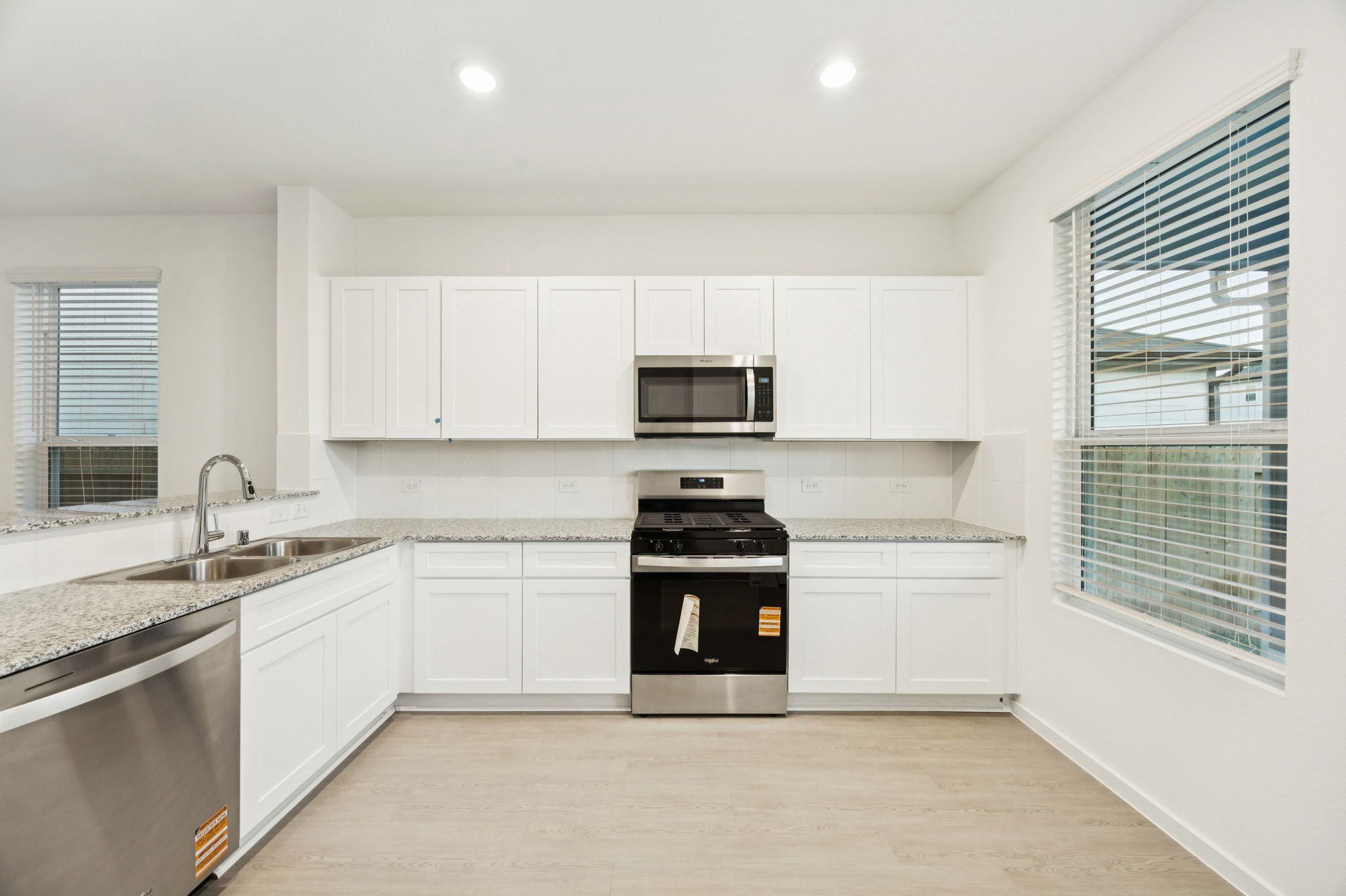 26266 Arrowleaf Drive Magnolia, TX 77355 - Photo 9 of 30 a kitchen with a stove and a microwave