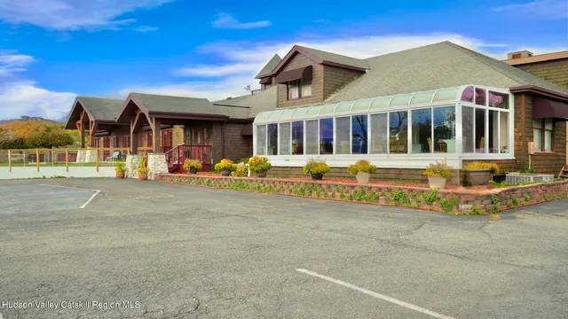 a front view of a building with a garden