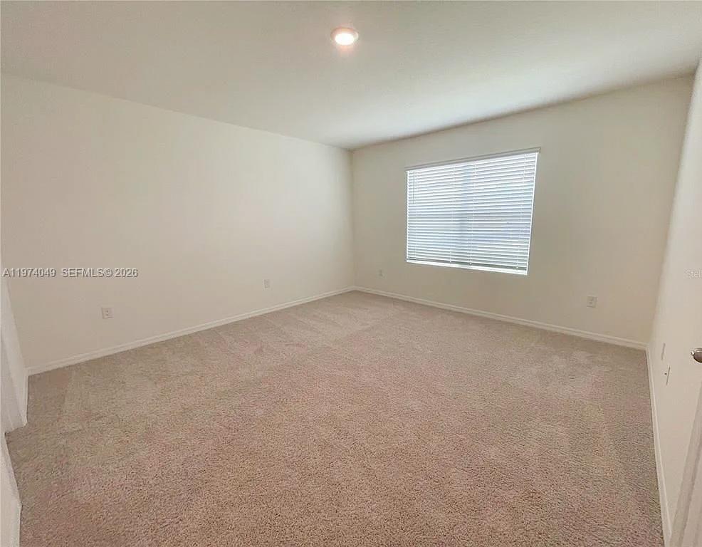 1556 Gladewater Road, Unit 1556 Kissimmee, FL 34744 - Photo 16 of 26 an empty room with a window