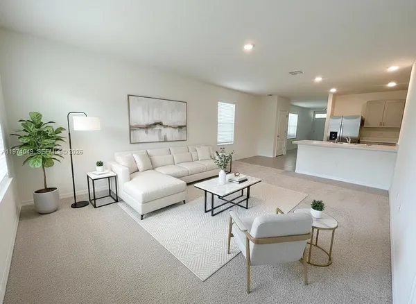 a living room with furniture and a potted plant