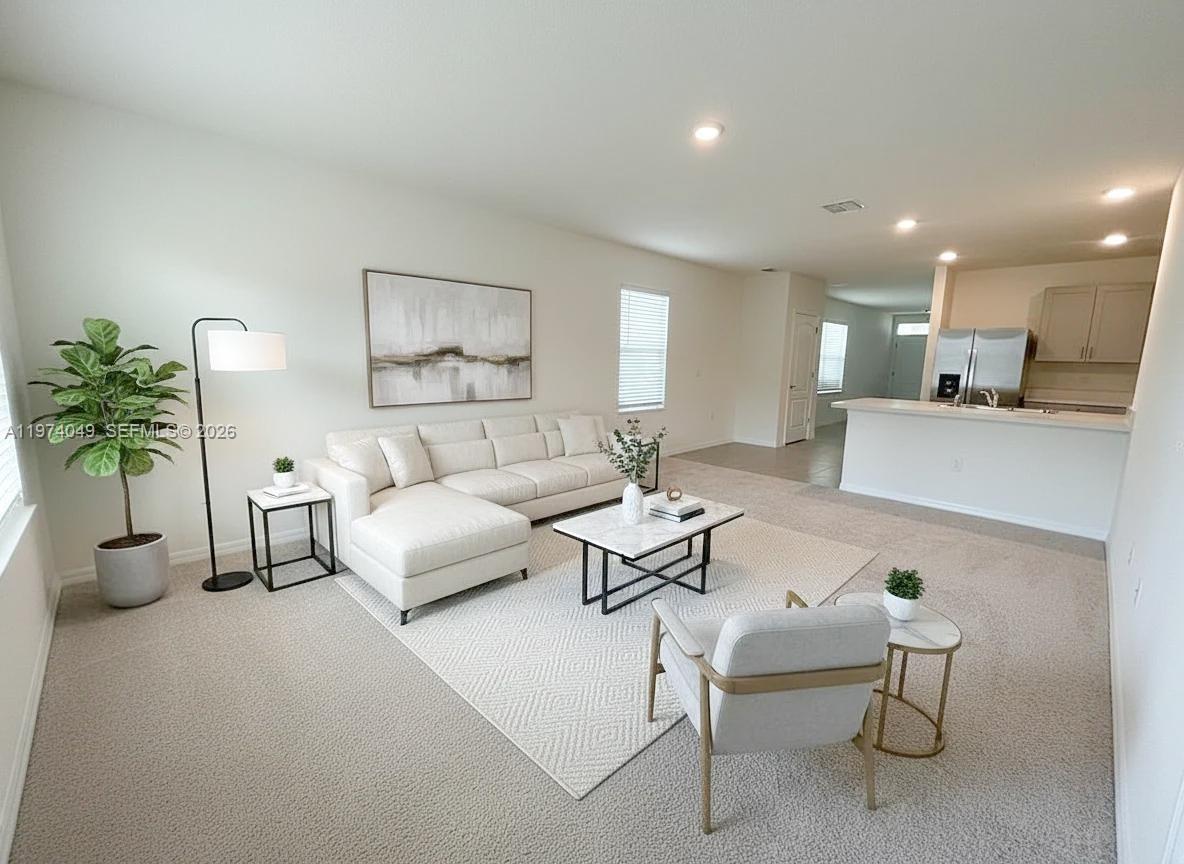 1556 Gladewater Road, Unit 1556 Kissimmee, FL 34744 - Photo 4 of 26 a living room with furniture and a potted plant