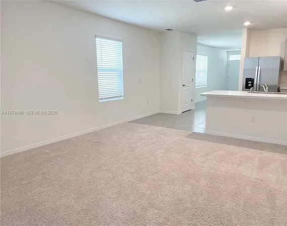a view of a kitchen with a sink and a mirror