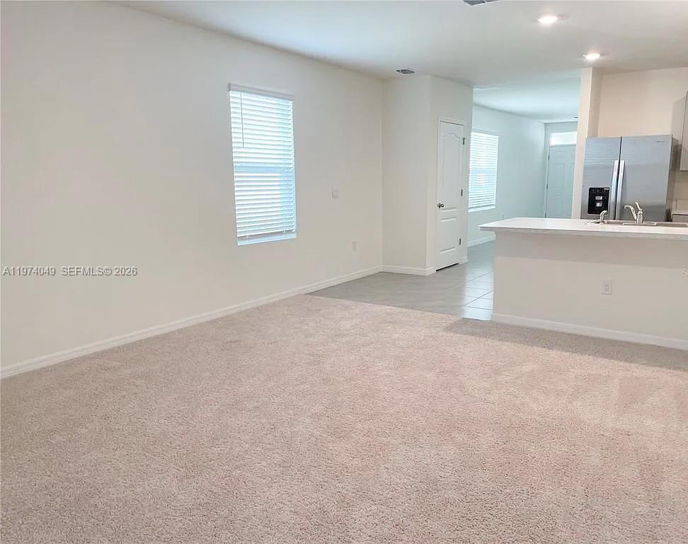 1556 Gladewater Road, Unit 1556 Kissimmee, FL 34744 - Photo 5 of 26 a view of a kitchen with a sink and a mirror