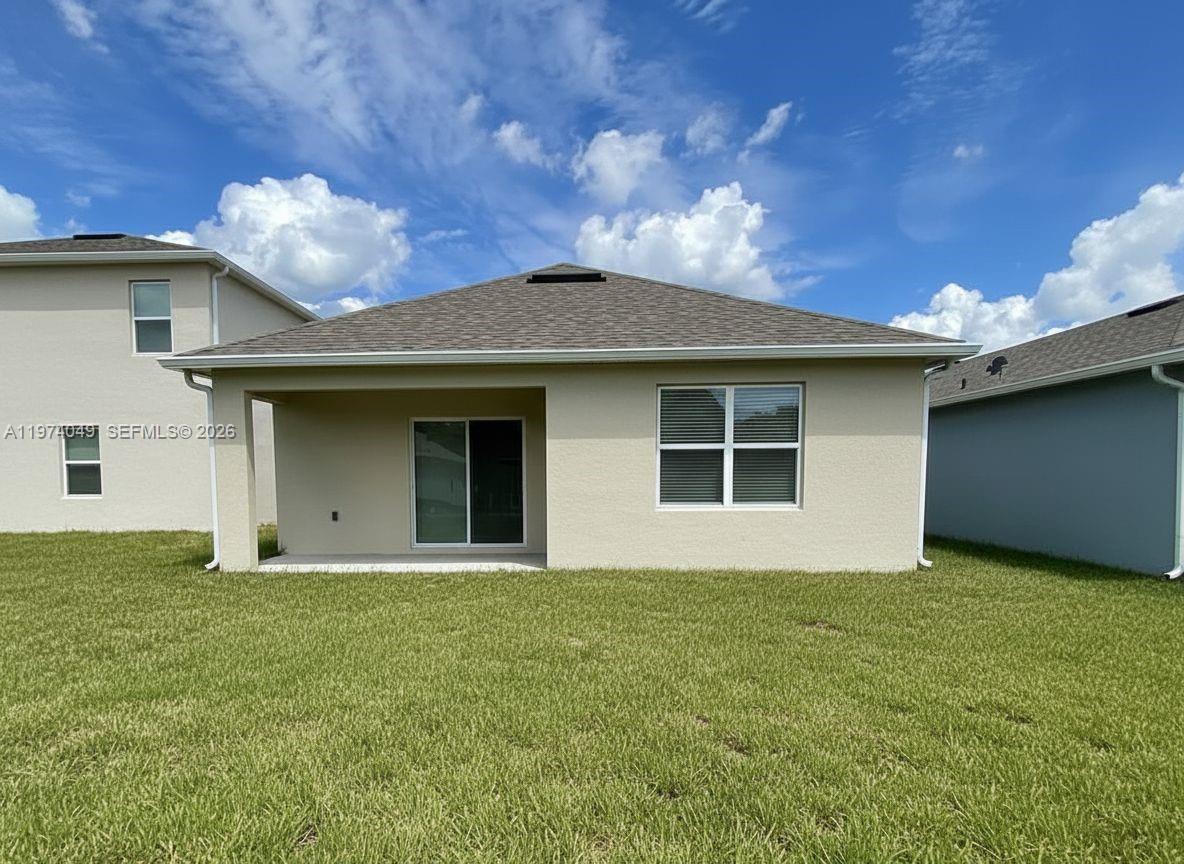 1556 Gladewater Road, Unit 1556 Kissimmee, FL 34744 - Photo 8 of 26 a view of a house with a yard