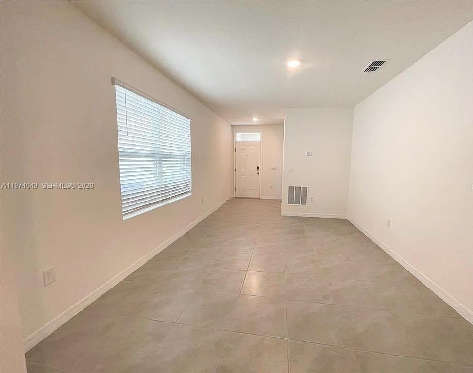 1556 Gladewater Road, Unit 1556 Kissimmee, FL 34744 - Photo 9 of 26 an empty room with windows