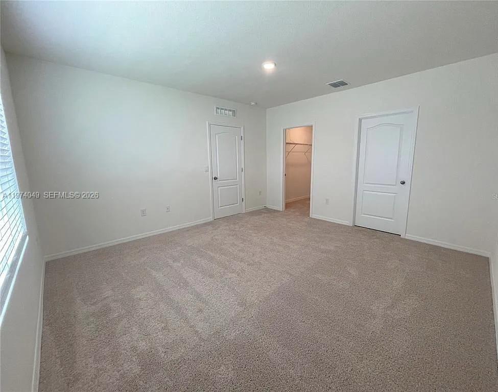 1556 Gladewater Road, Unit 1556 Kissimmee, FL 34744 - Photo 10 of 26 a view of an empty room with a window
