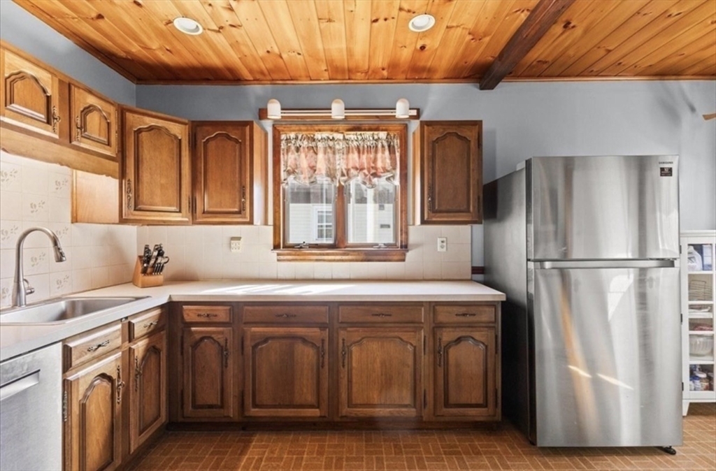 15 Belvoir Road, Unit 2 Milton, MA 02186 - Photo 7 of 13 a kitchen with stainless steel appliances granite countertop a refrigerator and a sink