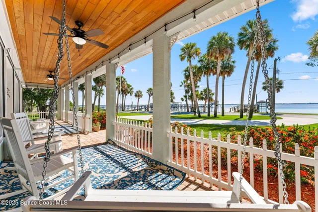 an aerial view of a house with a yard and lake view
