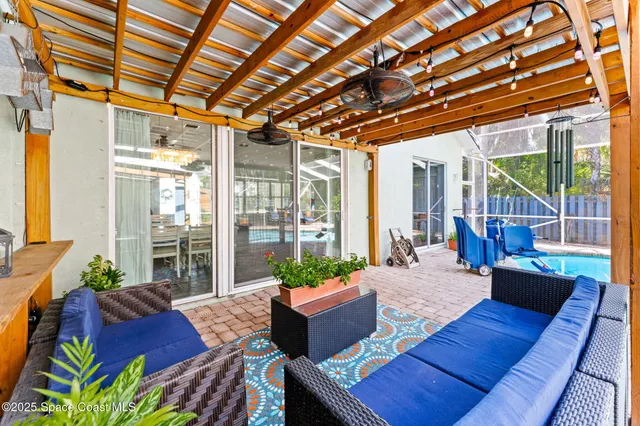 a kitchen that has a lot of white cabinets and stainless steel appliances