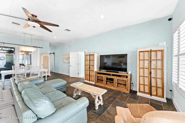 a spacious bathroom with a granite countertop sink and a mirror