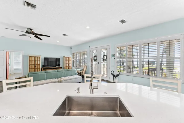 a view of a house with a yard and a lake view