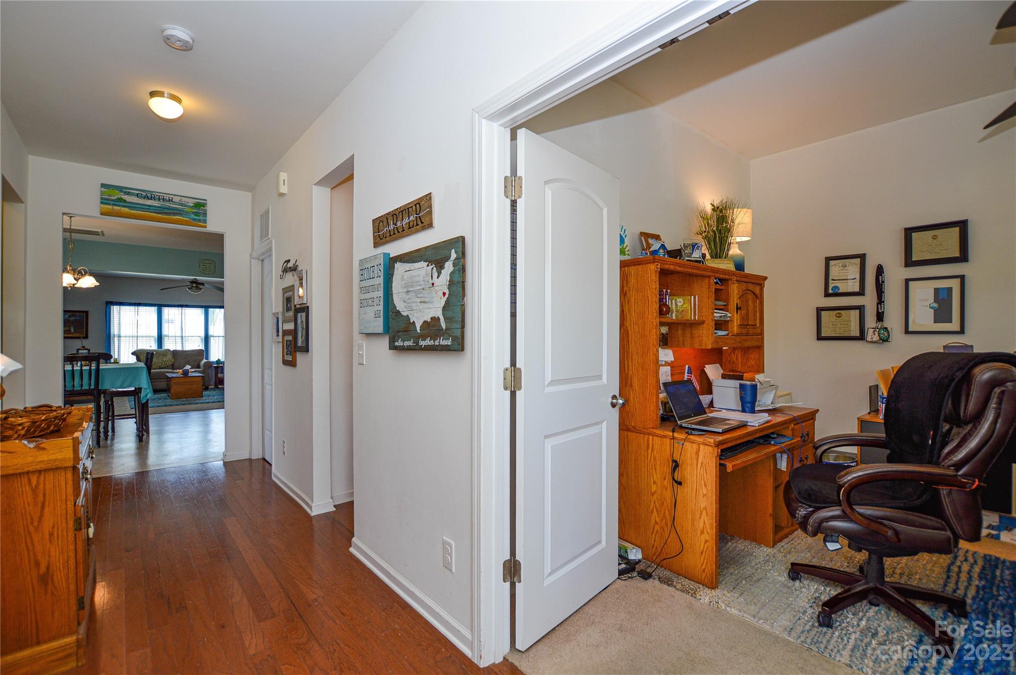 8191 Thornton Street Locust, NC 28097 - Photo 11 of 44 a view of a workspace with furniture and a livingroom