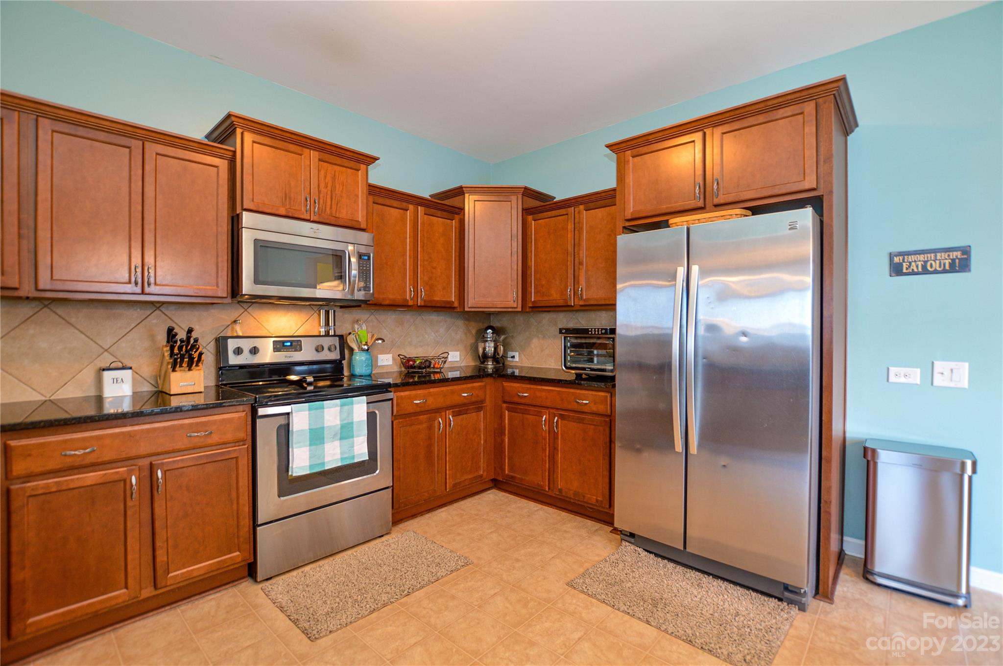 8191 Thornton Street Locust, NC 28097 - Photo 17 of 44 a kitchen with stainless steel appliances granite countertop a refrigerator a stove a sink and dishwasher