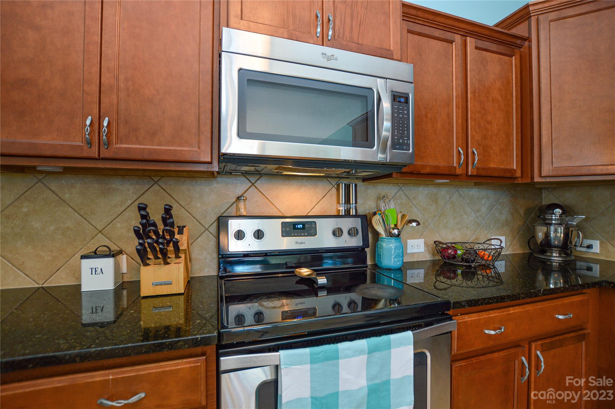 8191 Thornton Street Locust, NC 28097 - Photo 19 of 44 a kitchen with stainless steel appliances granite countertop a sink and cabinets