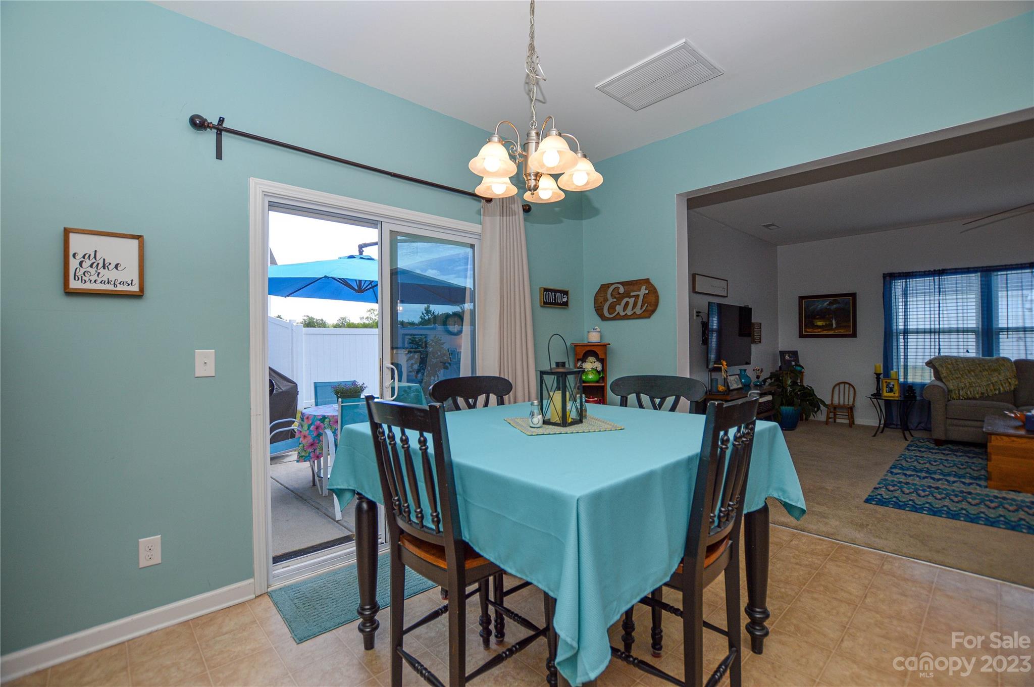 8191 Thornton Street Locust, NC 28097 - Photo 21 of 44 a view of a dining room with furniture a chandelier and wooden floor