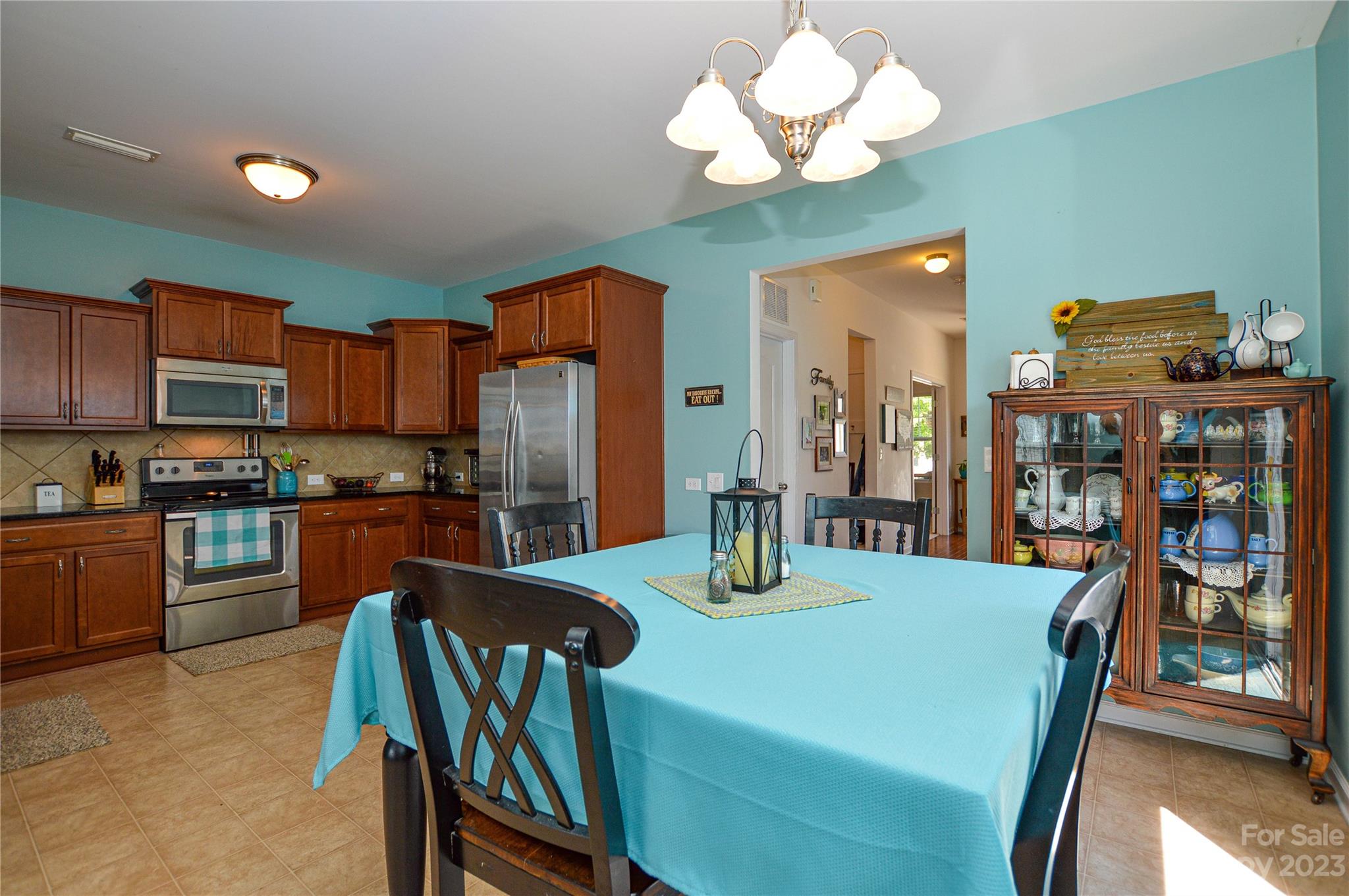 8191 Thornton Street Locust, NC 28097 - Photo 22 of 44 a view of a dining room with furniture a chandelier and wooden floor