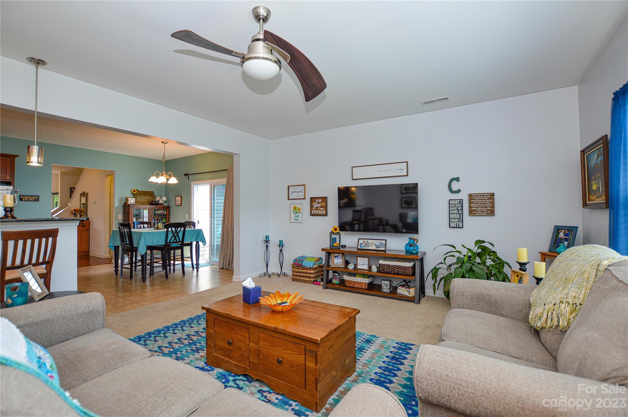 8191 Thornton Street Locust, NC 28097 - Photo 25 of 44 a living room with furniture and a flat screen tv