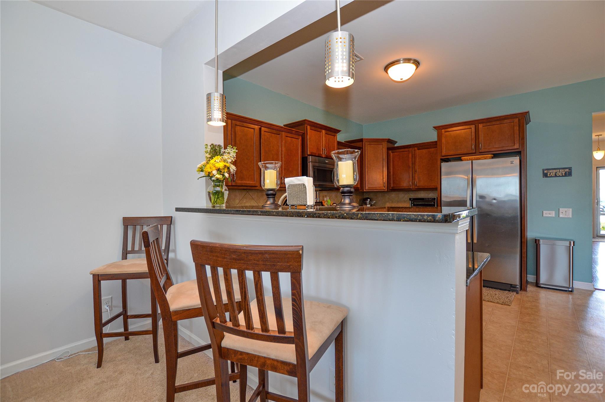 8191 Thornton Street Locust, NC 28097 - Photo 26 of 44 a kitchen with stainless steel appliances granite countertop a stove a sink and a refrigerator