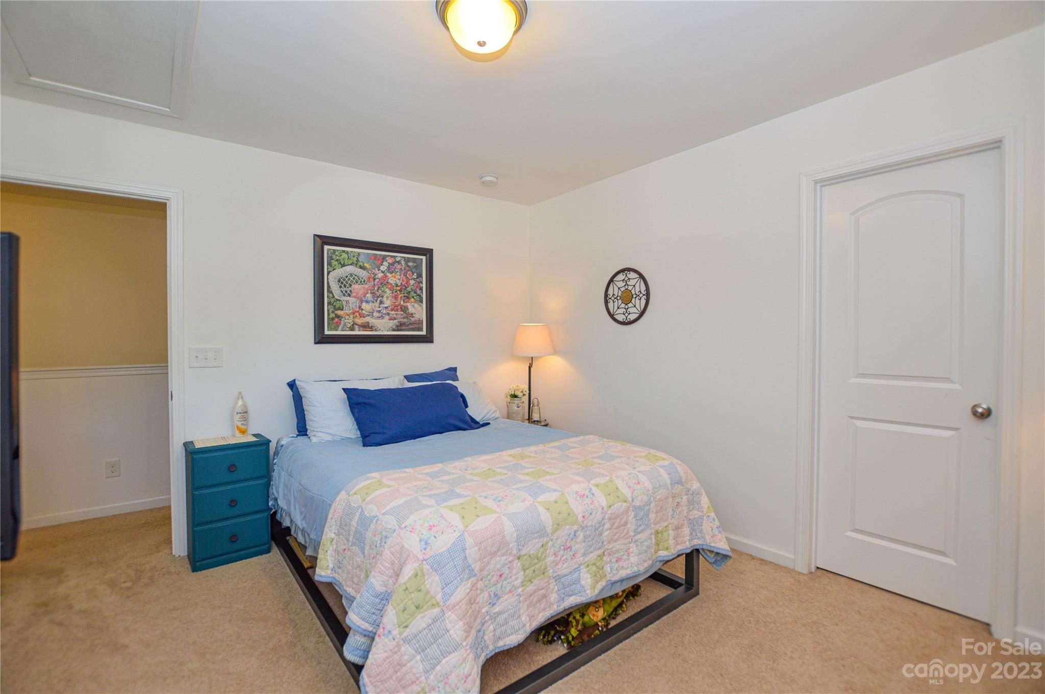 8191 Thornton Street Locust, NC 28097 - Photo 29 of 44 a bedroom with a bed and painting on the wall