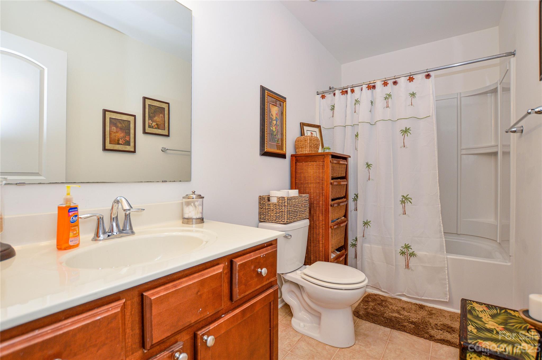 8191 Thornton Street Locust, NC 28097 - Photo 34 of 44 a bathroom with a sink a toilet and shower curtain