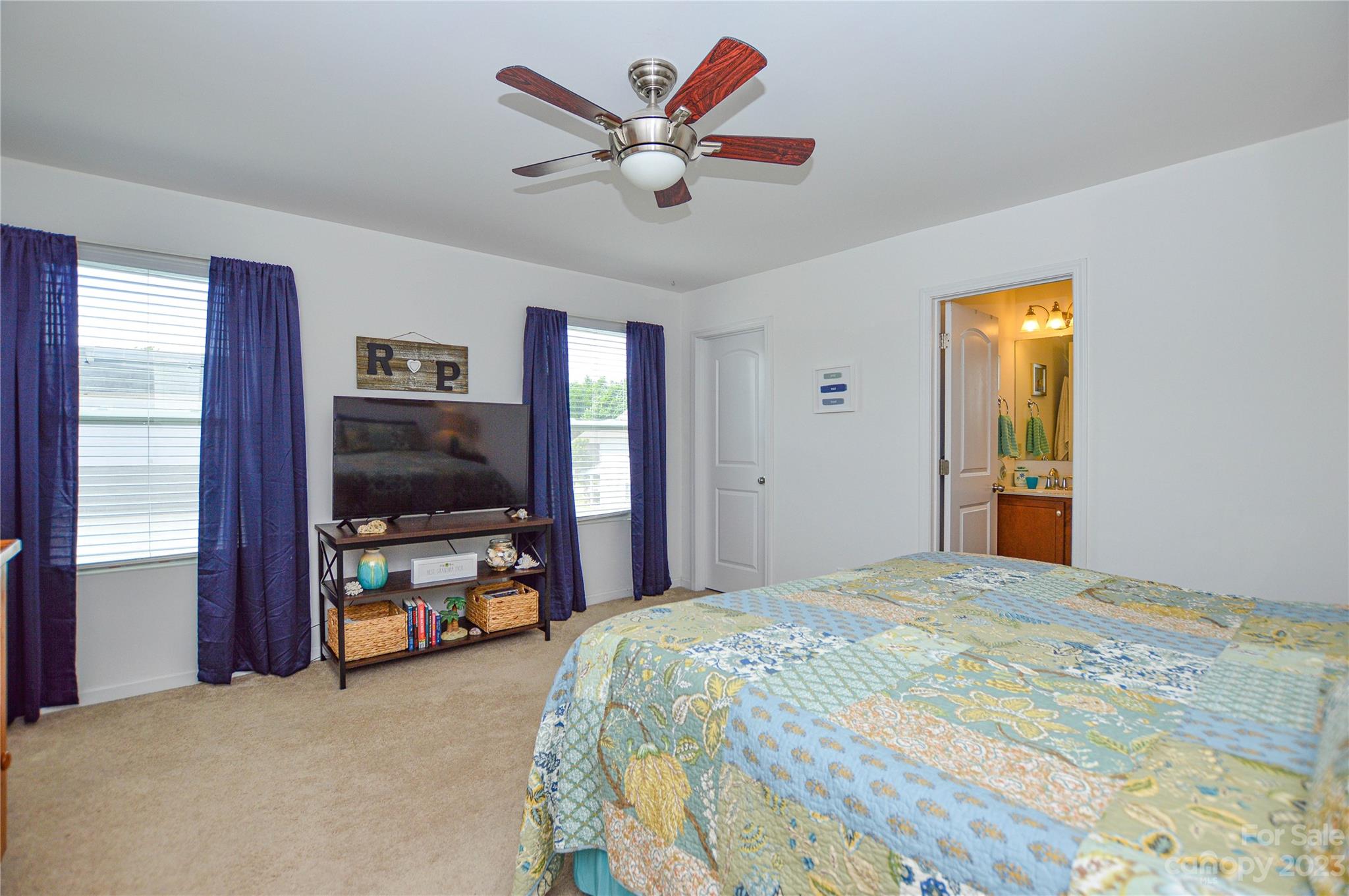 8191 Thornton Street Locust, NC 28097 - Photo 35 of 44 a bedroom with a bed and a flat screen tv