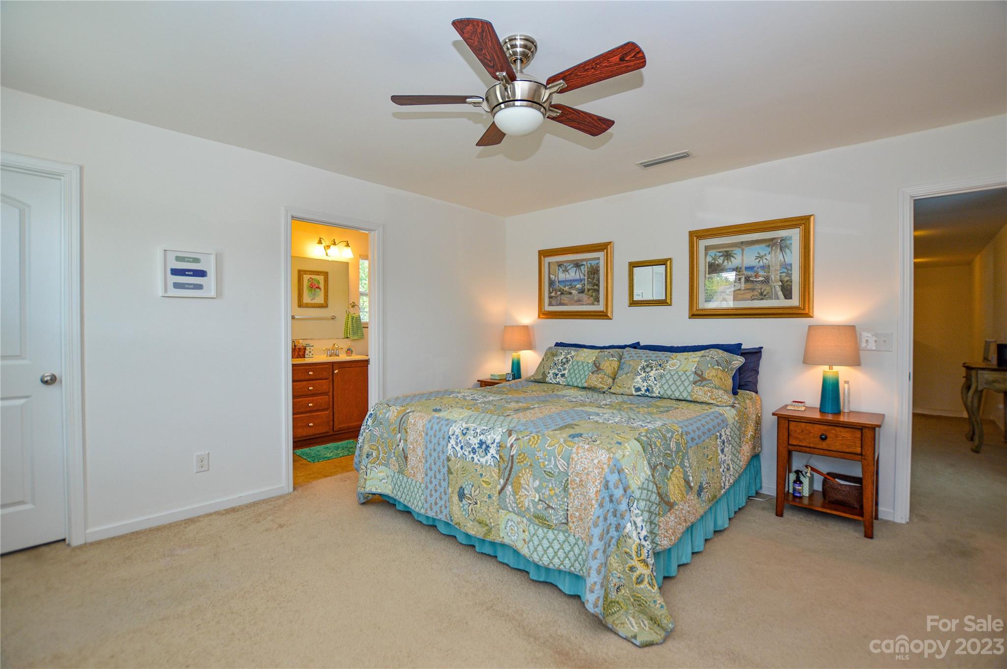 8191 Thornton Street Locust, NC 28097 - Photo 36 of 44 a spacious bedroom with a bed and a chandelier