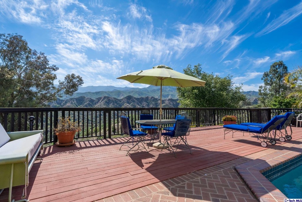 24718 Sagecrest Circle Newhall, CA 91381 - Photo 12 of 36 a view of a balcony with wooden floor and outdoor seating