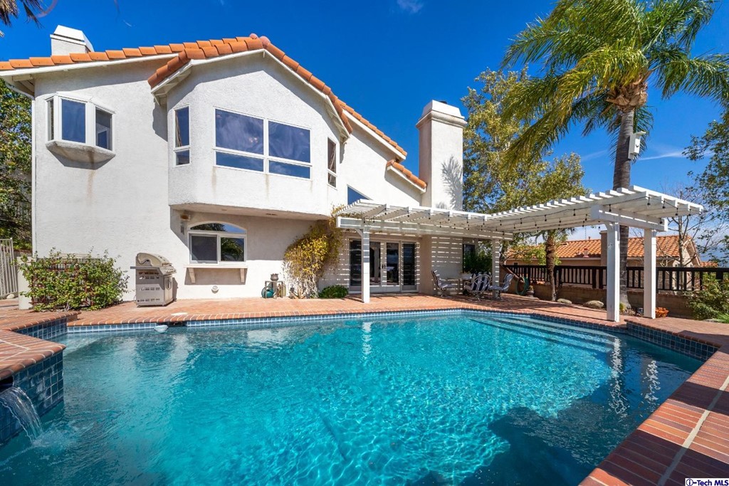 24718 Sagecrest Circle Newhall, CA 91381 - Photo 15 of 36 a view of a house with a swimming pool