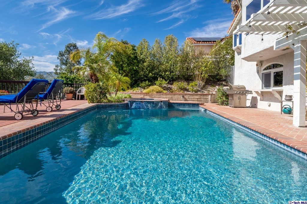 24718 Sagecrest Circle Newhall, CA 91381 - Photo 17 of 36 a view of a swimming pool with a patio