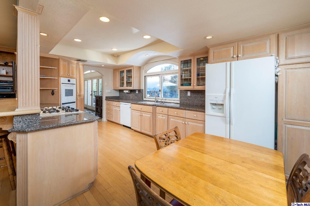 24718 Sagecrest Circle Newhall, CA 91381 - Photo 22 of 36 a kitchen with stainless steel appliances granite countertop a sink refrigerator and cabinets