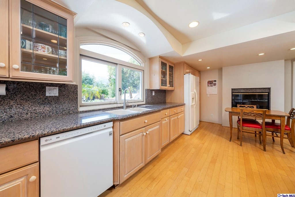24718 Sagecrest Circle Newhall, CA 91381 - Photo 24 of 36 a large kitchen with kitchen island a large window in it and a sink