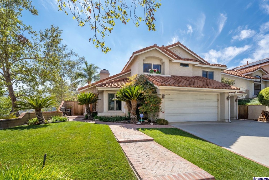 24718 Sagecrest Circle Newhall, CA 91381 - Photo 3 of 36 a front view of house with yard and green space