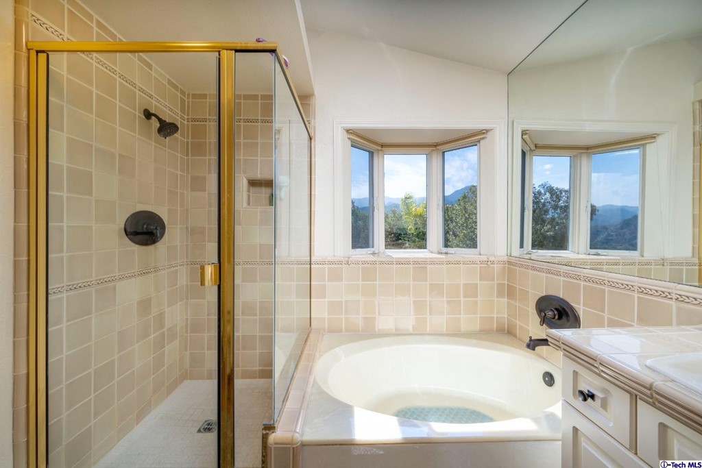 24718 Sagecrest Circle Newhall, CA 91381 - Photo 33 of 36 a bathroom with a tub a sink and a window