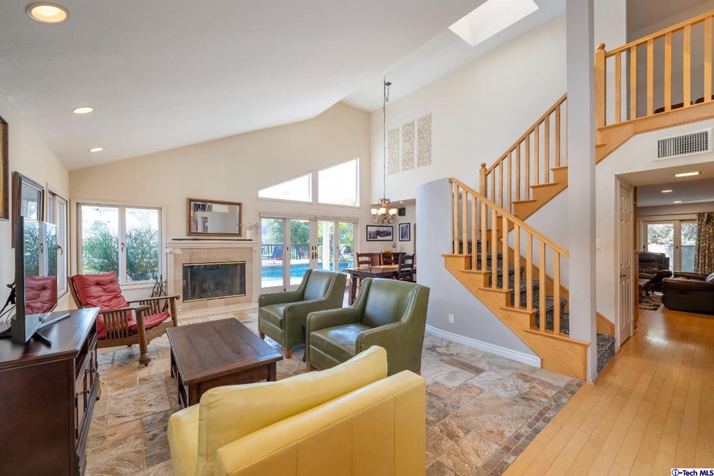 24718 Sagecrest Circle Newhall, CA 91381 - Photo 4 of 36 a living room with fireplace furniture and a dining table