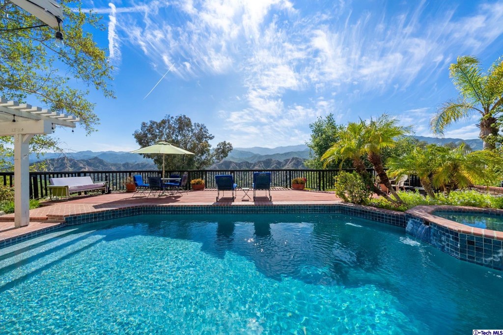 24718 Sagecrest Circle Newhall, CA 91381 - Photo 7 of 36 a view of a swimming pool with a yard
