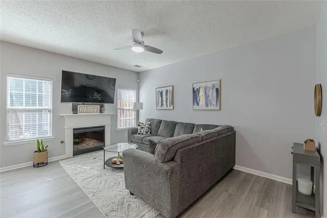 a living room with furniture and a wooden floor