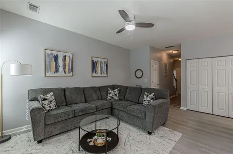a living room with furniture kitchen view and a dining table