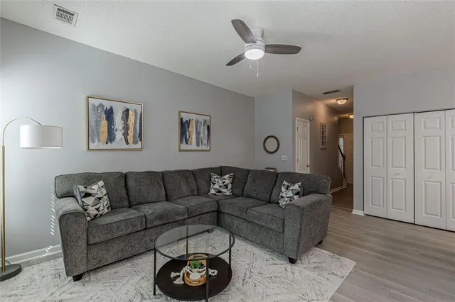 a living room with furniture kitchen view and a dining table
