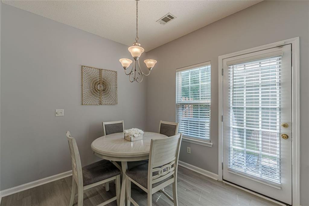 7640 Rutgers Circle Fairburn, GA 30213 - Photo 19 of 49 a view of a dining room with furniture window and wooden floor
