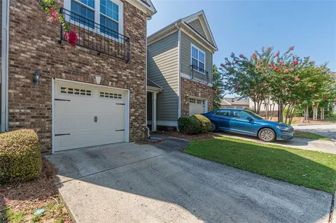 a view of a house with a backyard and a garage