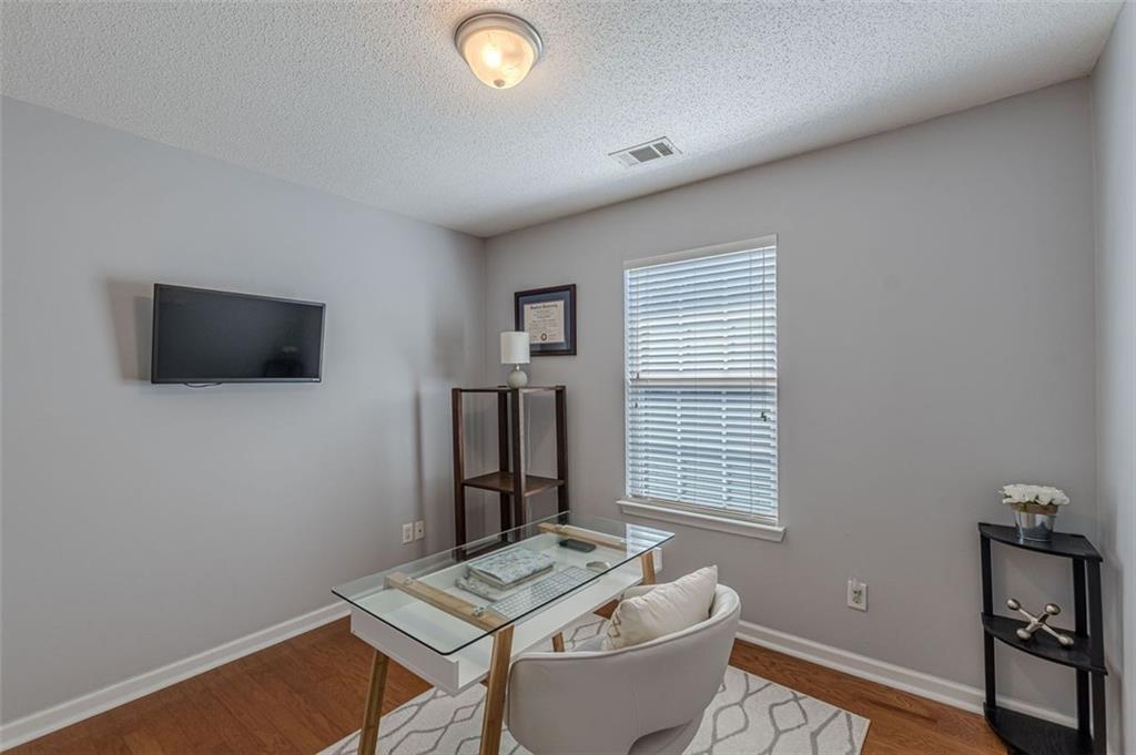 7640 Rutgers Circle Fairburn, GA 30213 - Photo 28 of 49 a living room with furniture and a flat screen tv