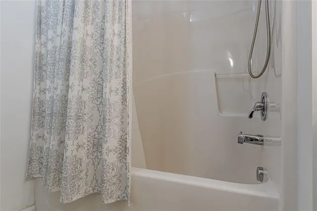 a bathroom with a shower and a sink